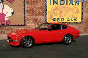 red 240z by the brick wall