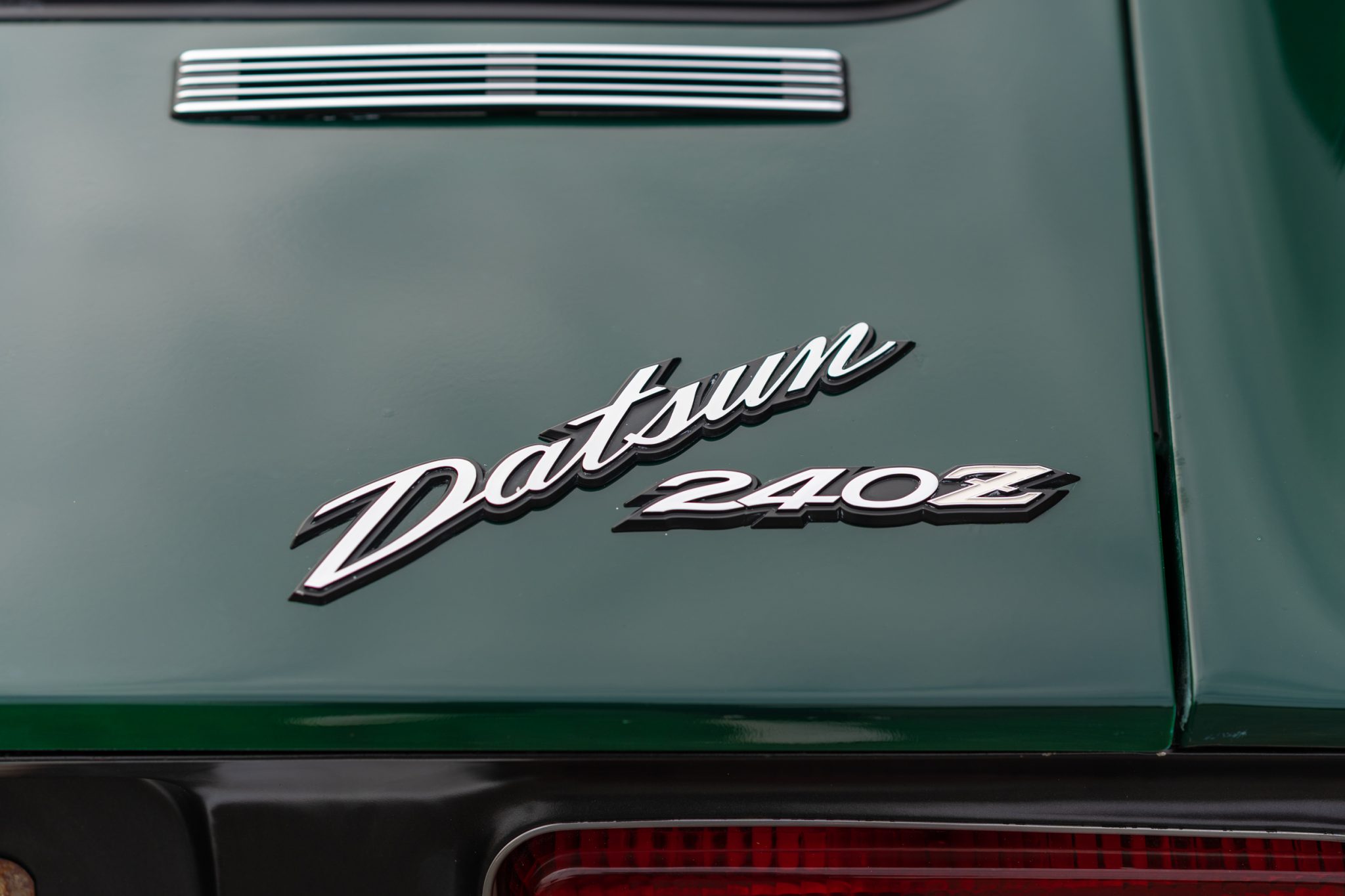 "Datsun" script badge on hatch