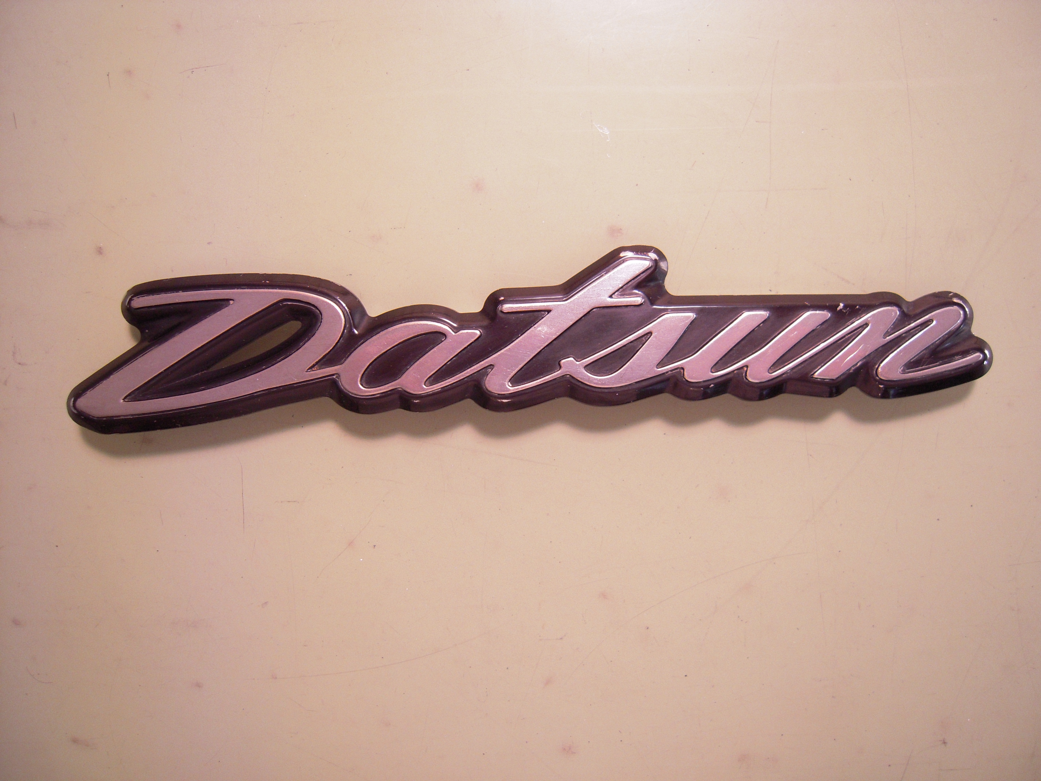 "Datsun" Script Hatch Emblem
